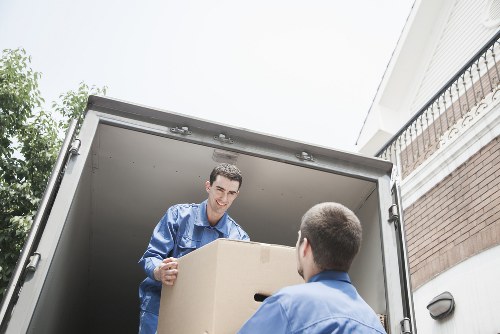 Removal team handling boxes and furniture for a Westminster apartment move